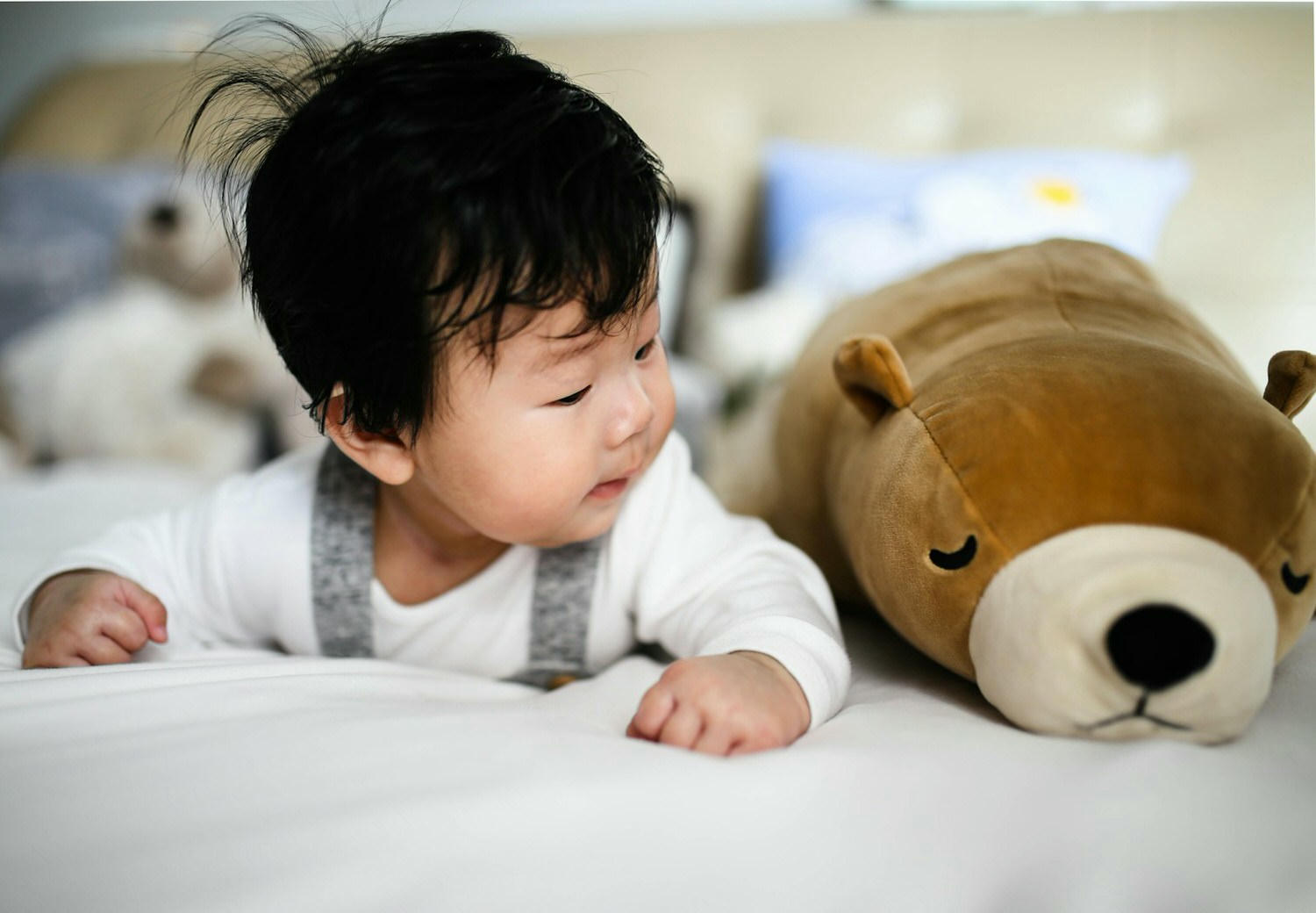 baby looking at plush toy